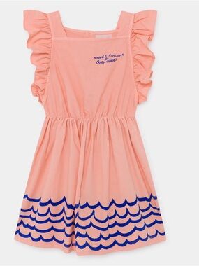 Bobo Choses "Waves Woven Ruffle Dress" in a peachy color with blue design detail